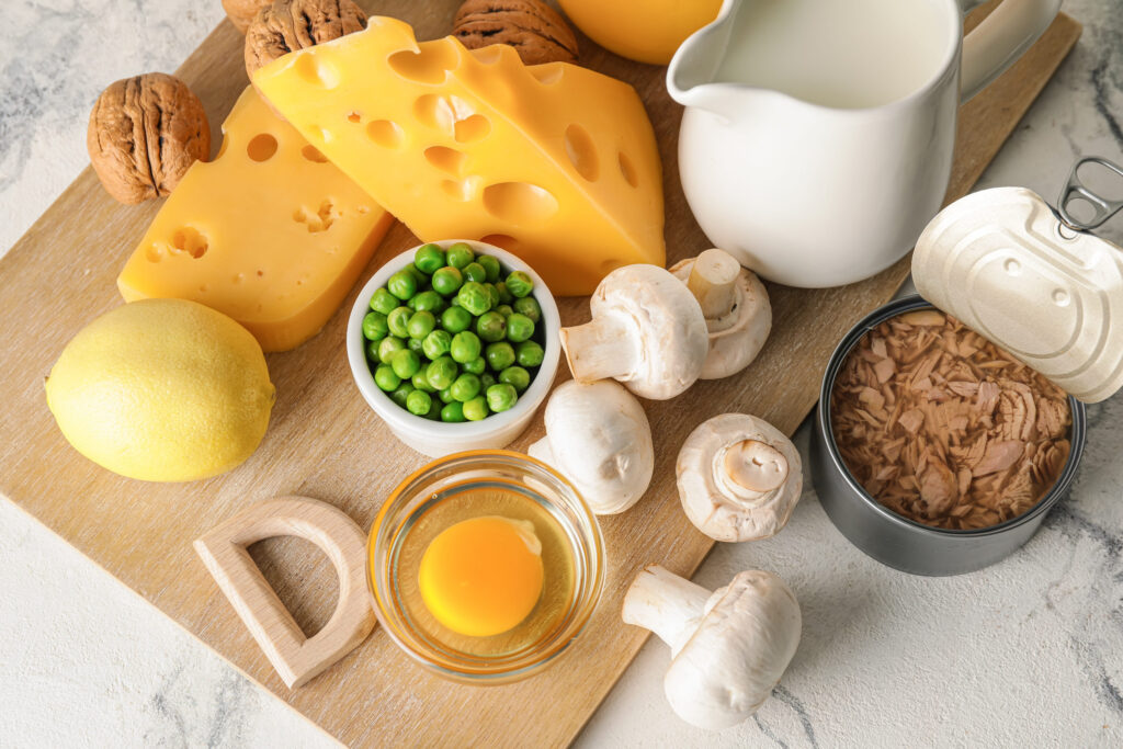 Letter D and different healthy products on light background